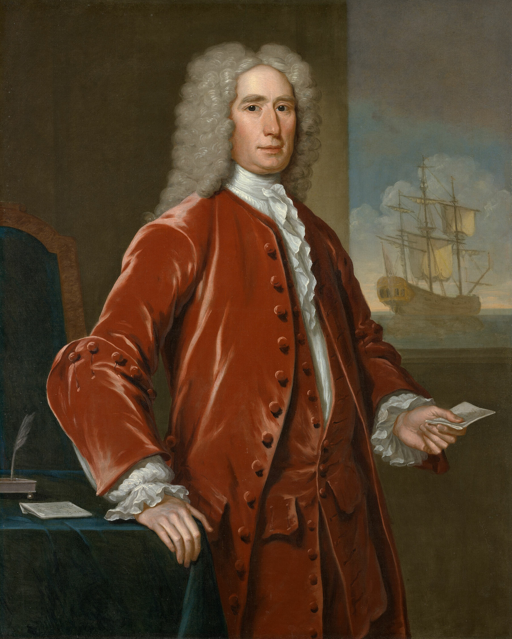 Portrait of Richard Bill wearing a vivid red-orange eighteenth-century suit with lace cuffs, standing beside a writing table.